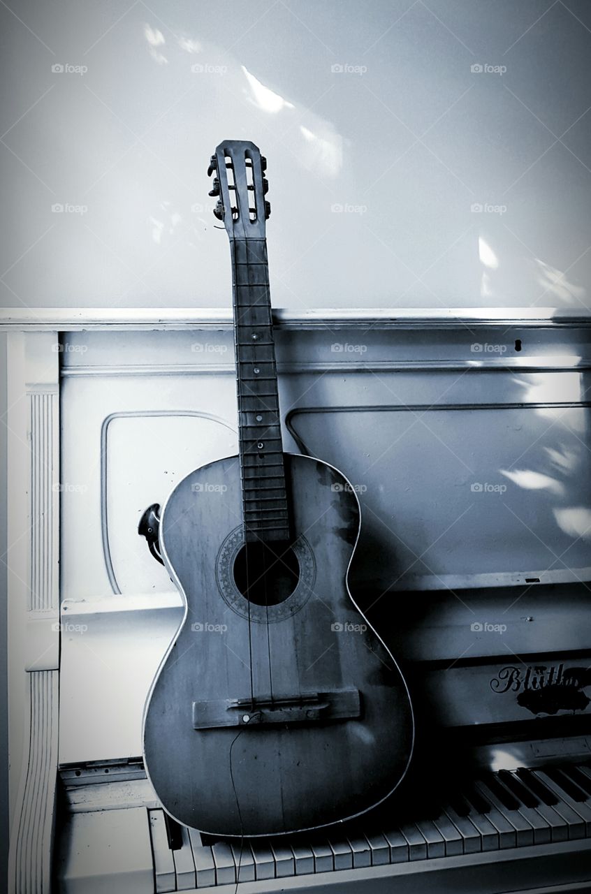 Old music instruments. Old guitar and piano