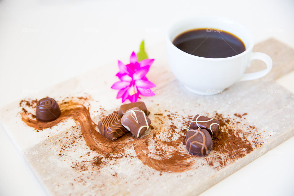 Sugar coffee and cocoa on marble with white background and pink flower. Close up of sugar sweet chocolate