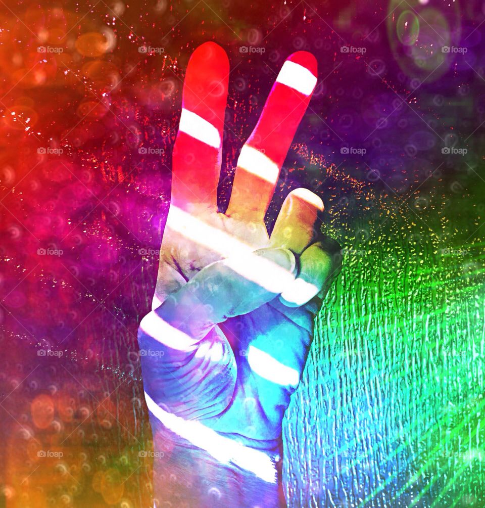 Psychedelic hand gesture representing the hope for peace.