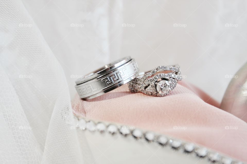 These are our gorgeous wedding rings on a shell ring holder 