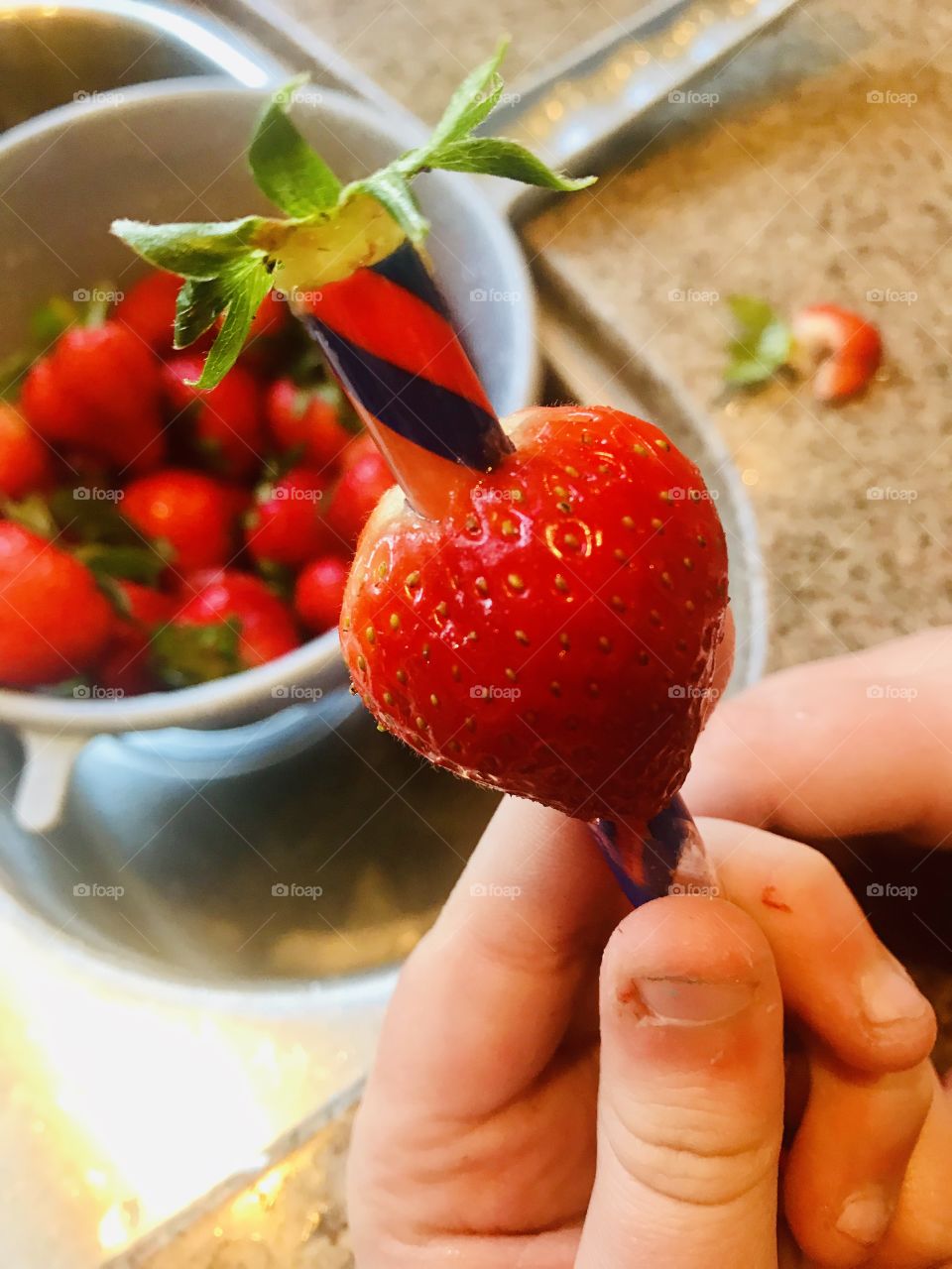 This is how we like to eat strawberries! Use a plastic straw to remove the core of the strawberry! 