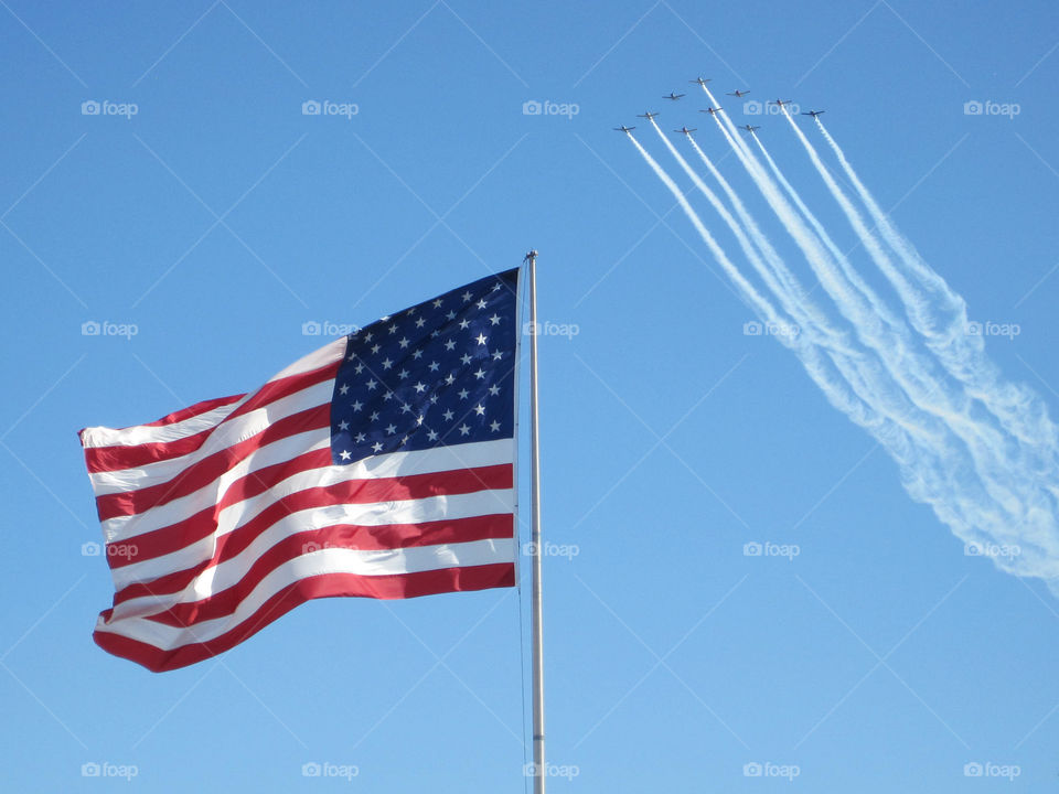 Stars and Stripes with a military fly over 