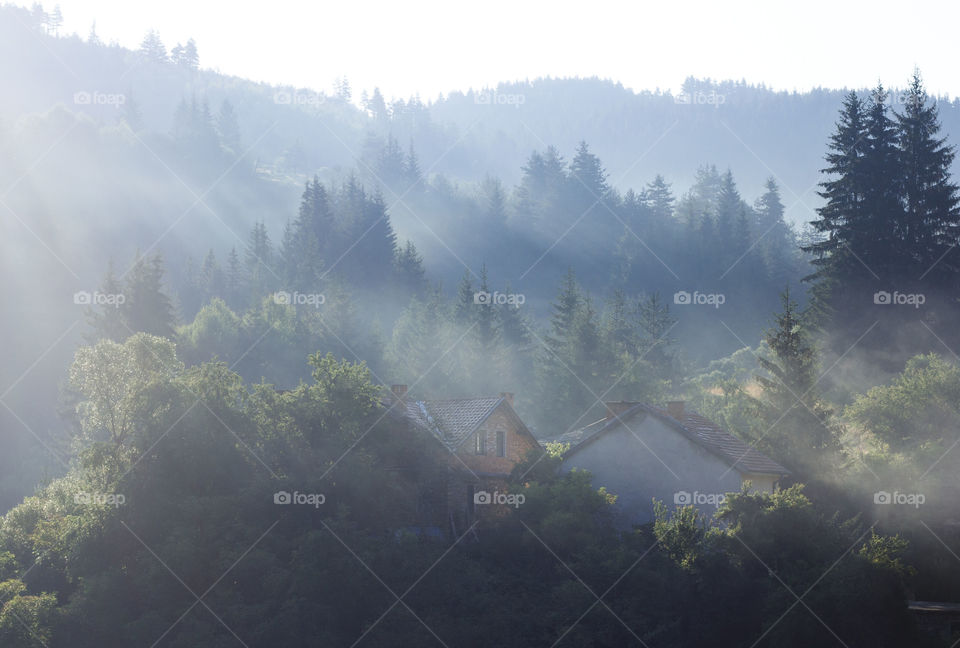 Sunrise over the mountain, trees and small town