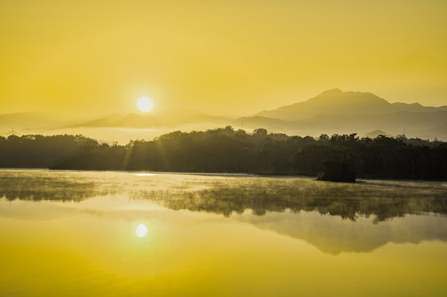 Beautiful sunrise and mountains reflection