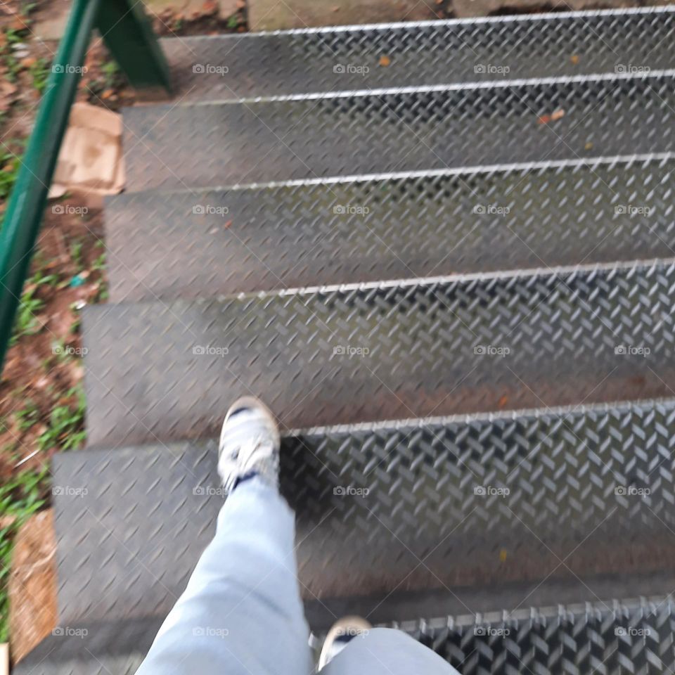 lonely steps down the stairs sneakers blue jeans