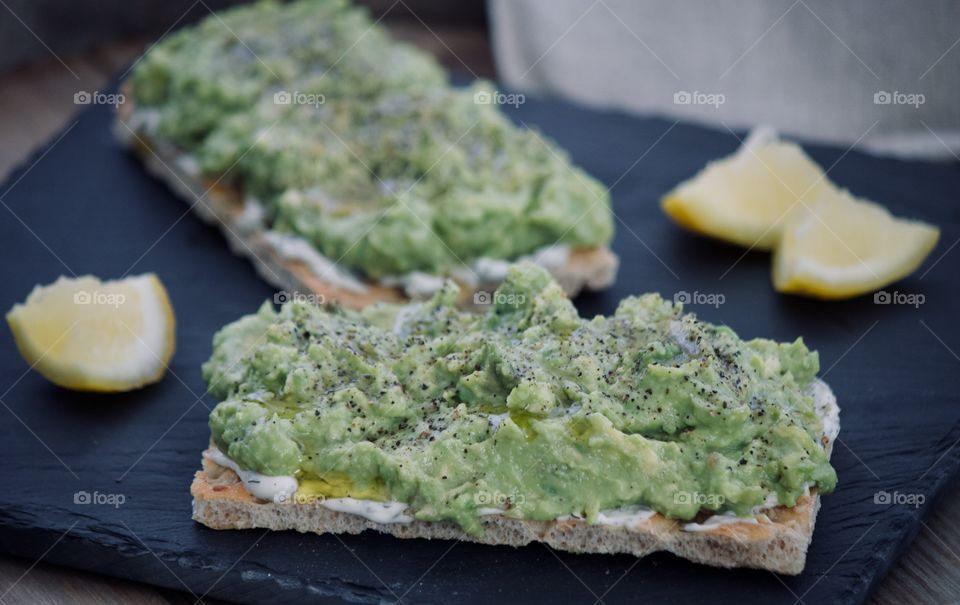 Avocado toast drizzled with olive oil