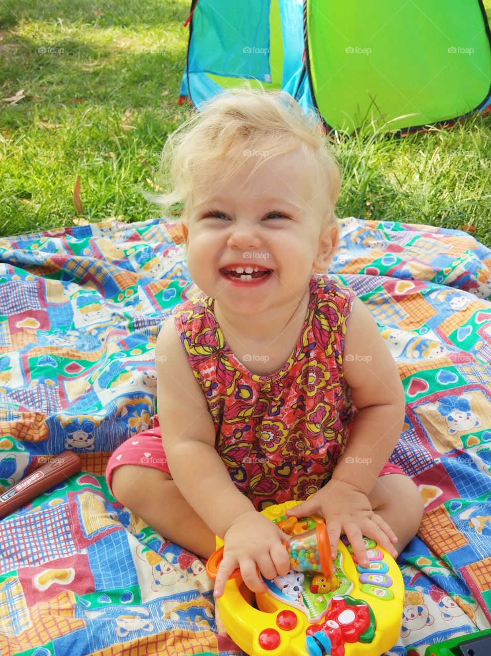 Cute happy toddler playing with toy