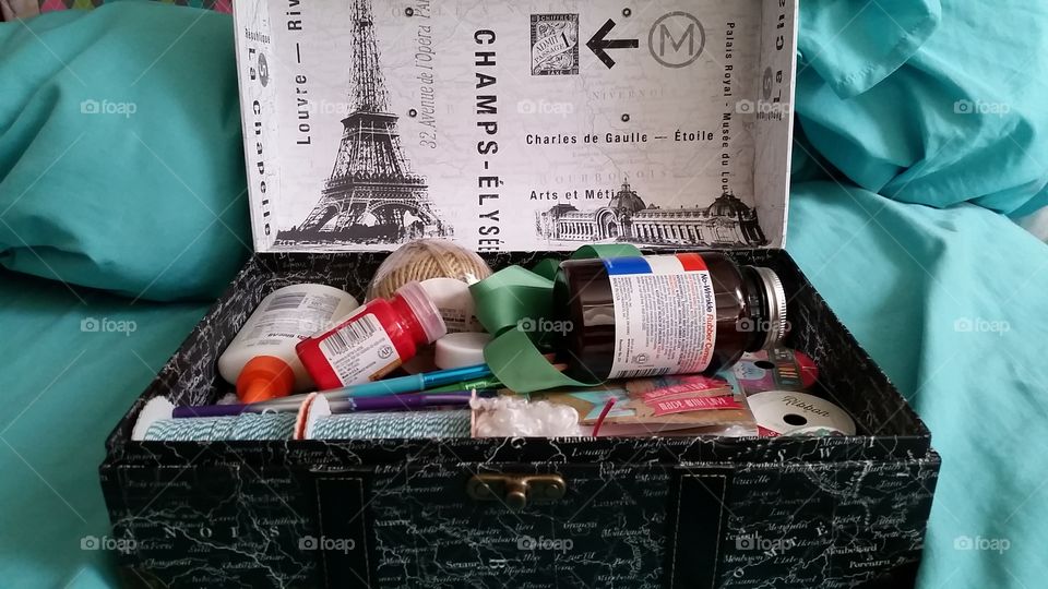 a box designed with Paris sites, filled with craft supplies