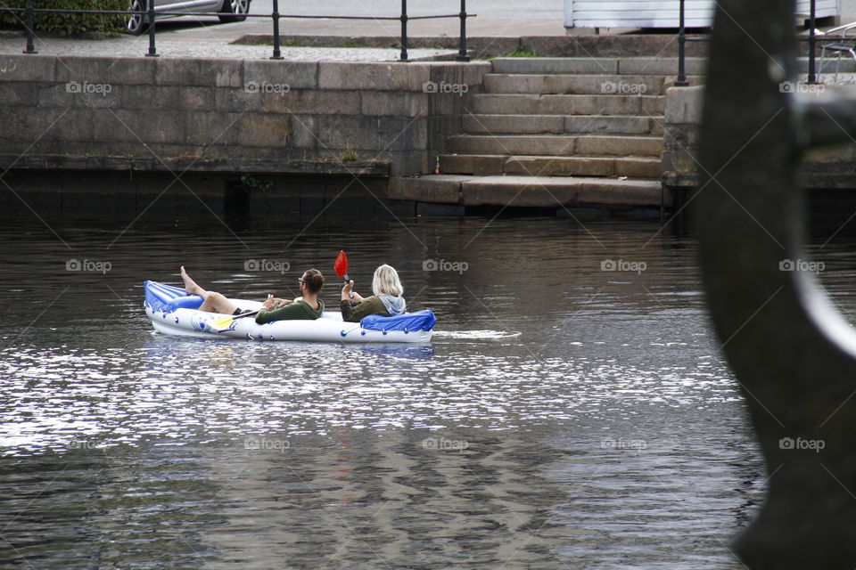 couple with their kayak on the river