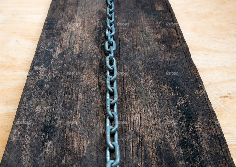Metal chain on the dark wooden