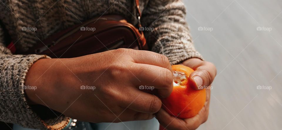 Peeling off the skin of orange