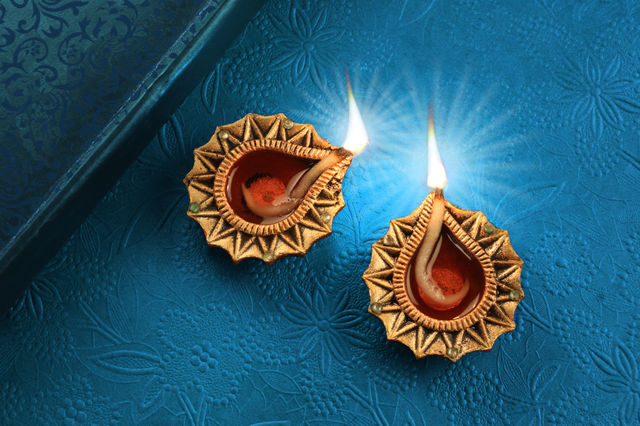Golden Diwali Diya on blue textured background