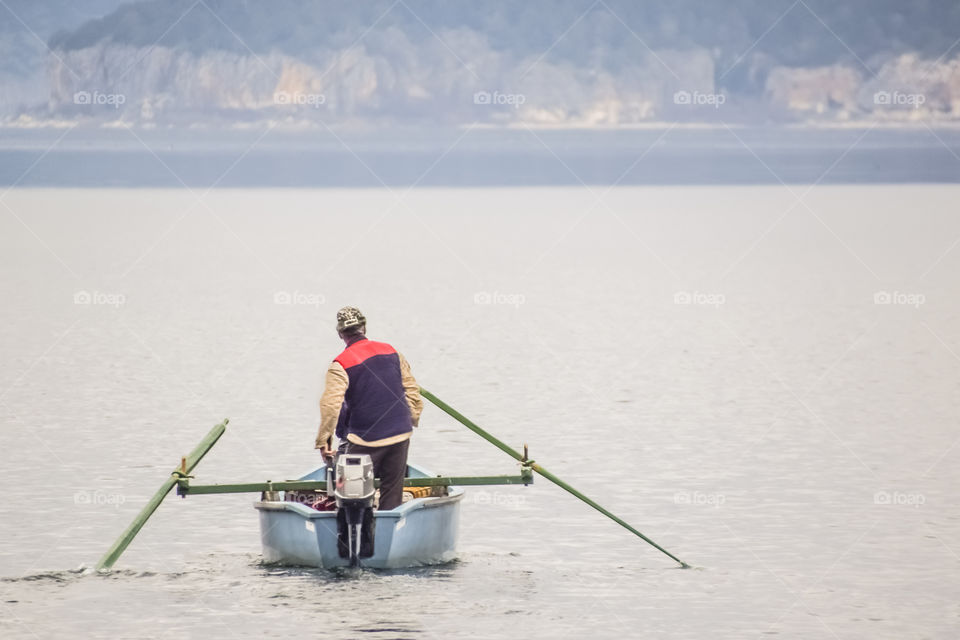 Fisherman With His Boat Going For Fishing
