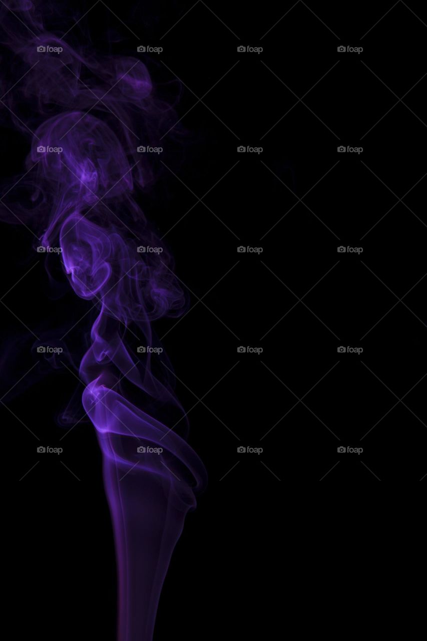 Blue abstract smoke swirling on black background