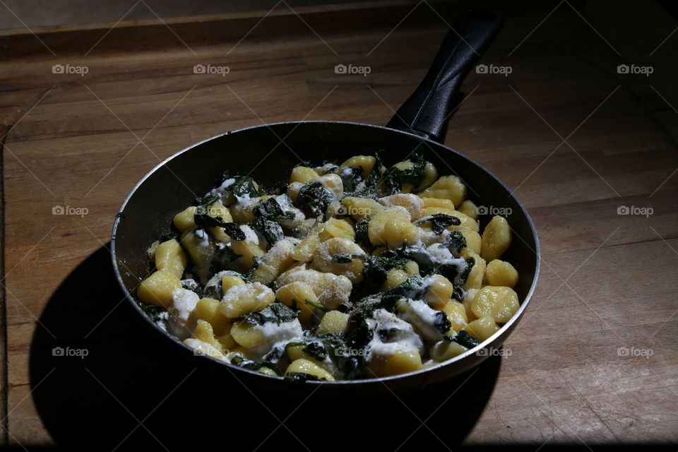 High angle view Of pesto gnocchi With spinach