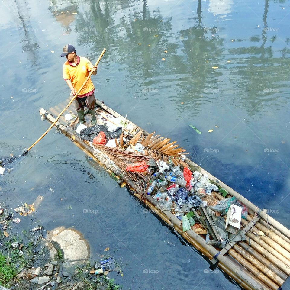 for a better life. photo taken in the city of jakarta at one of the canal.only quarter of people in jakarta received a clean water for daily usage.this big city have a numbers of big problem,pollution,dirty,traffic and flood.