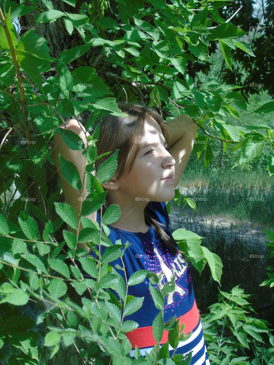 girl in the shade of trees