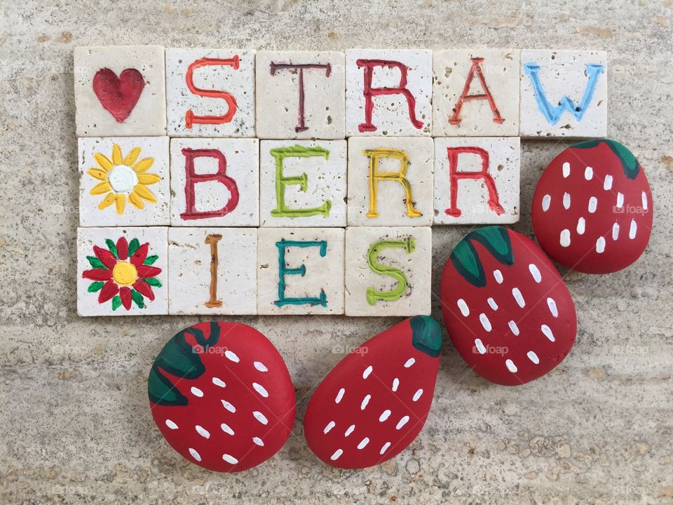 I love strawberries. Stone painted with strawberries design
