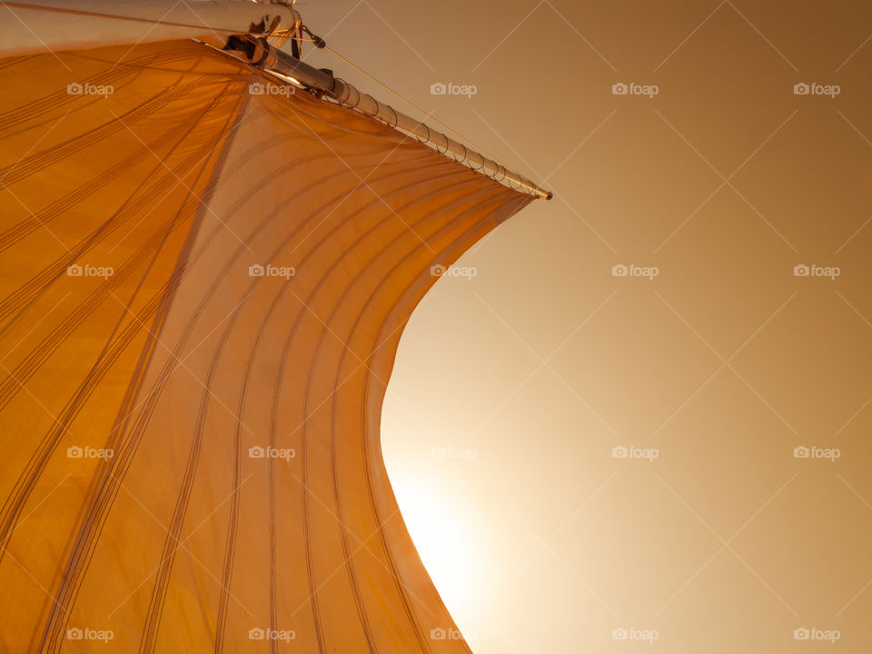 Sail on mast during sunset.