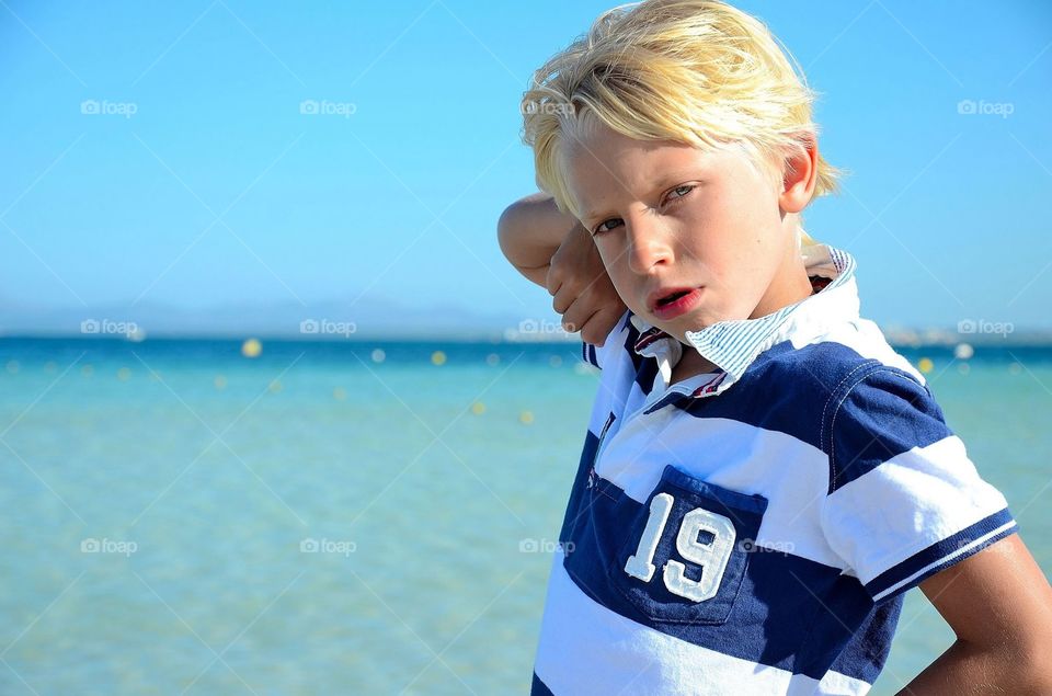 Close-up of a boy at seaside