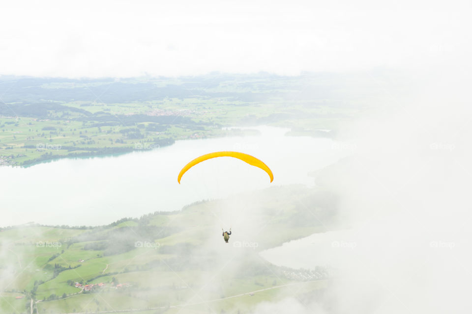 fog in the Alps and a paraglider
