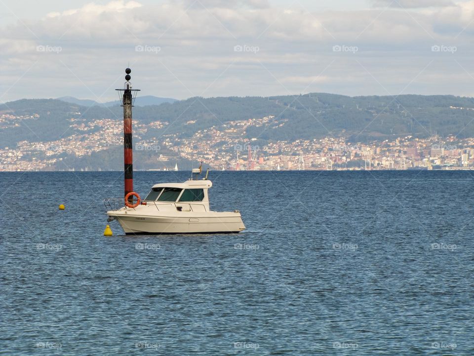 A boat on a City landscape sourrounded by water