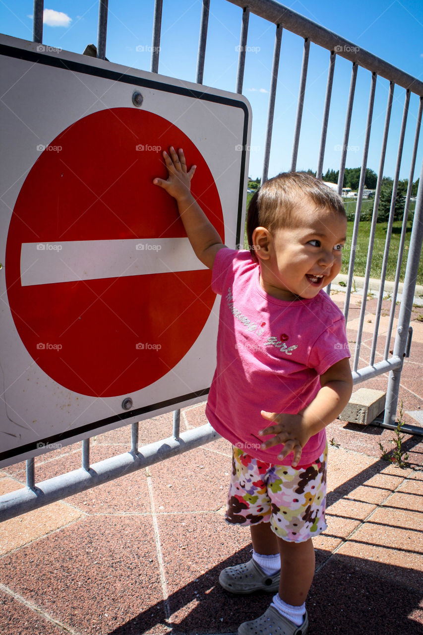 Cute toddler and a stop sign