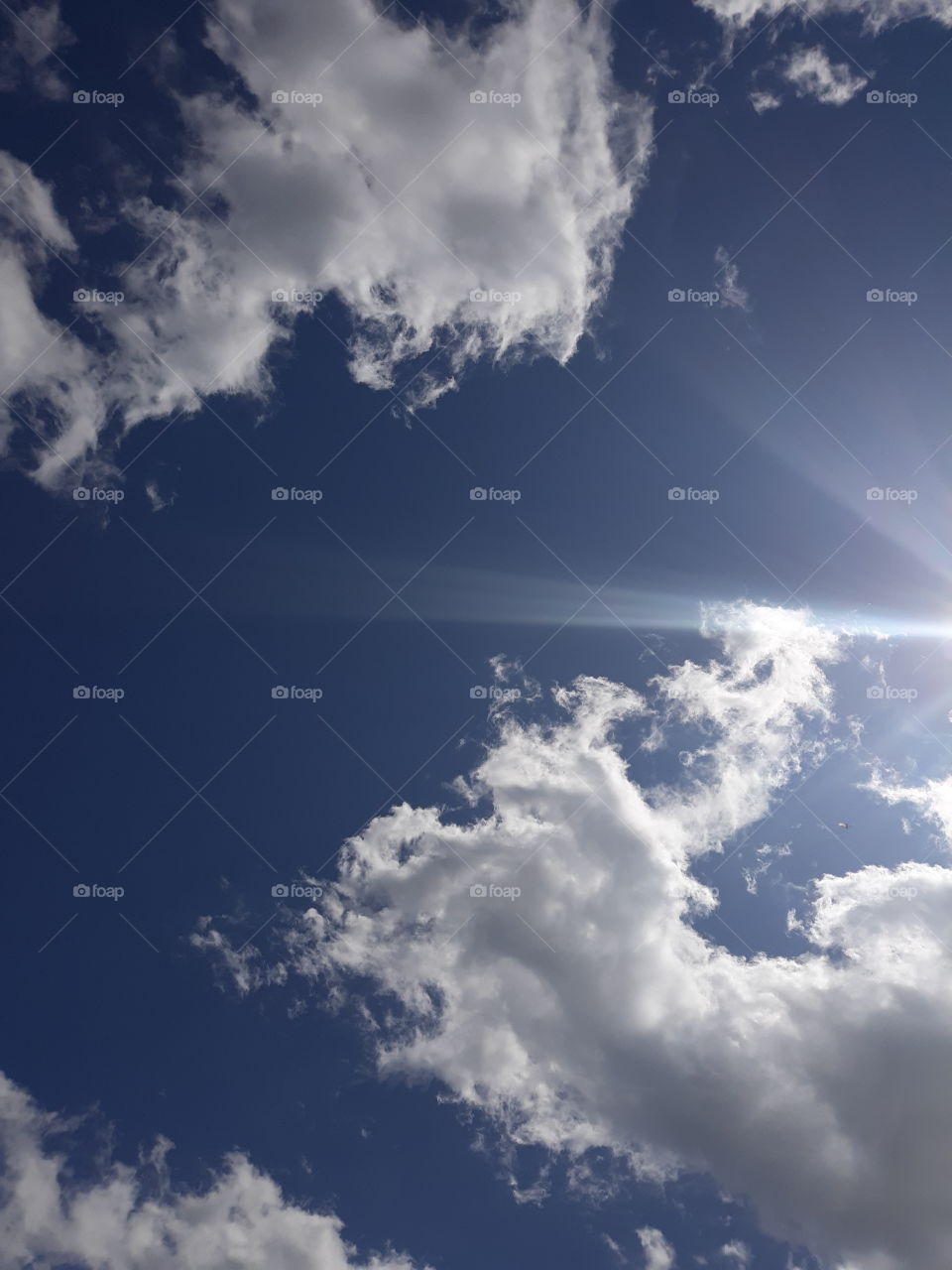 Clouds in the sunny blue sky