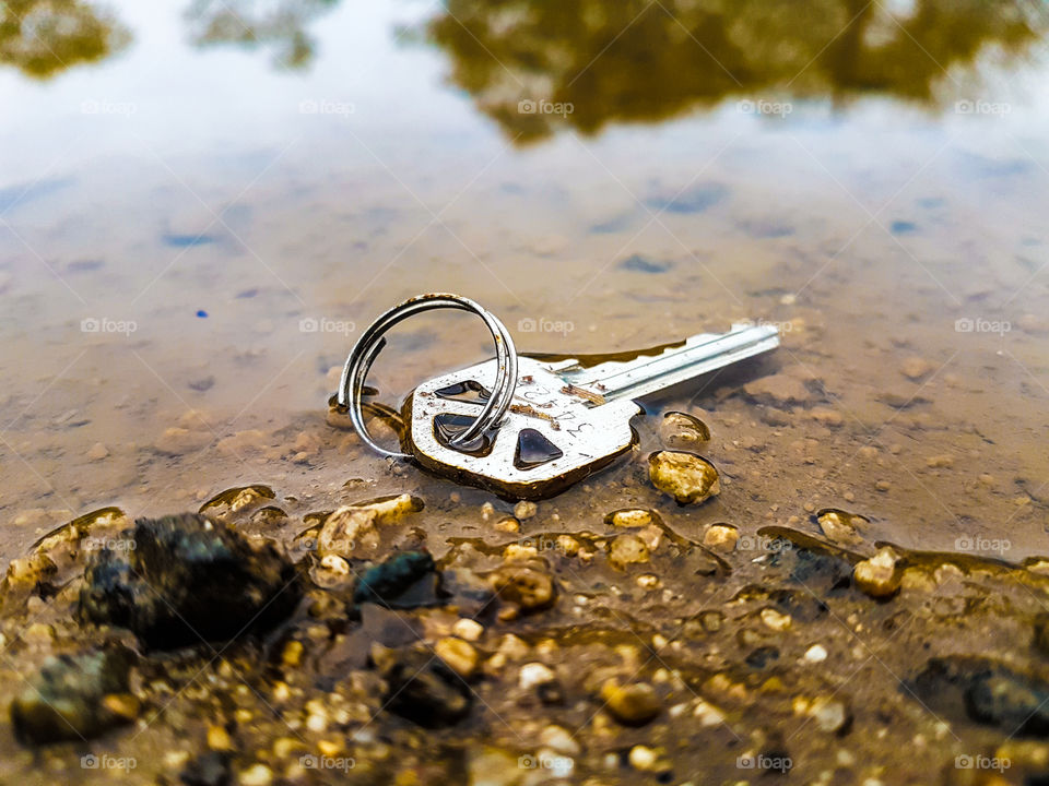 meral key with ring in water