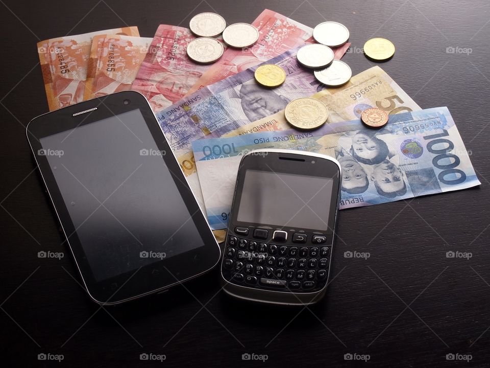 smartphones and money. smartphones and bills of money and coins