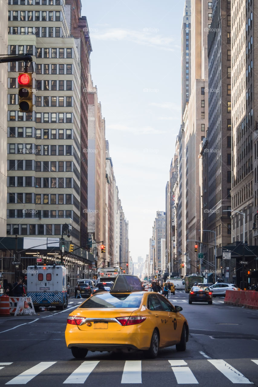 Yellow cab in the streets of Manhattan at morning time 