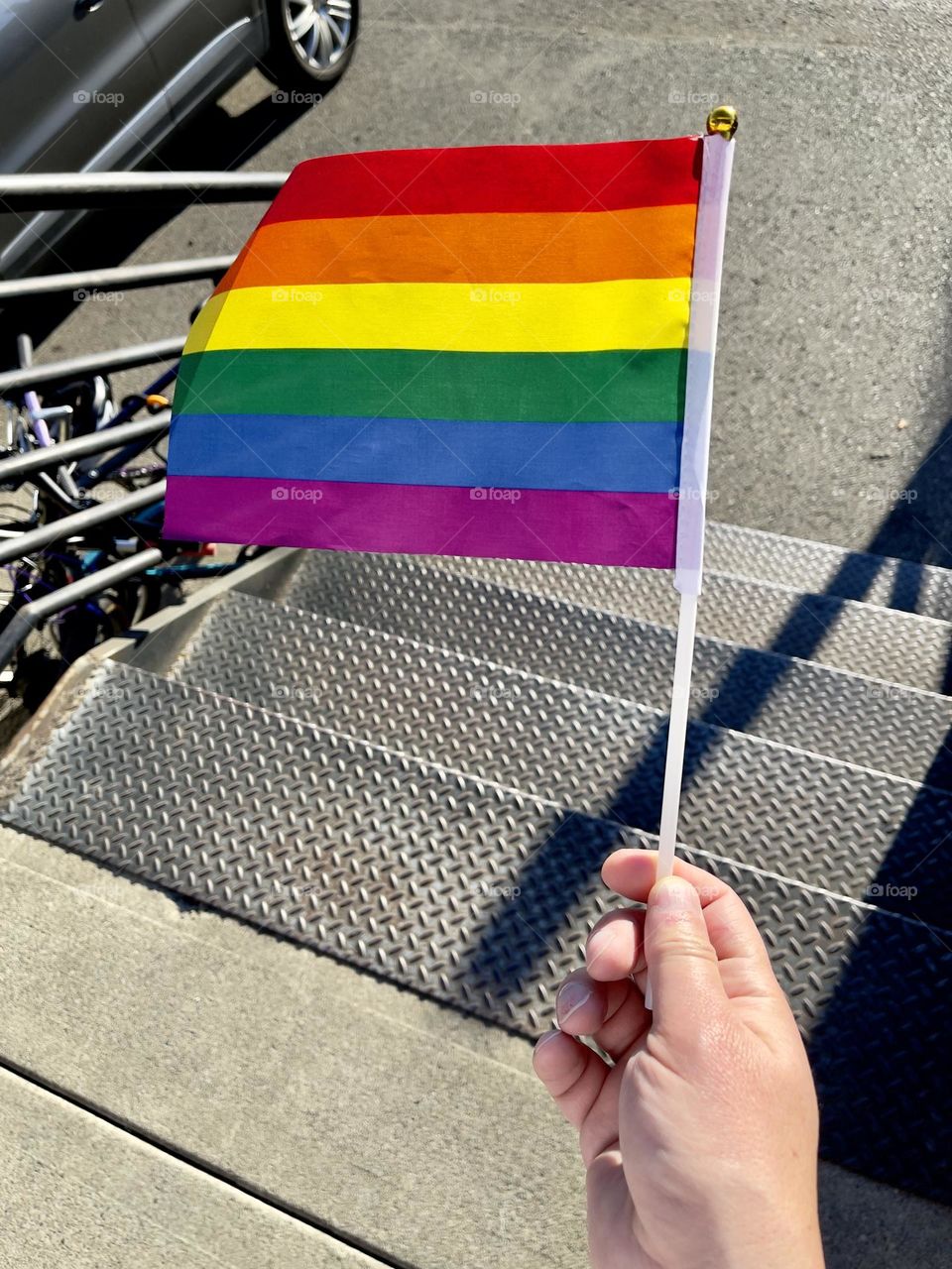 Rainbow flag in man hand