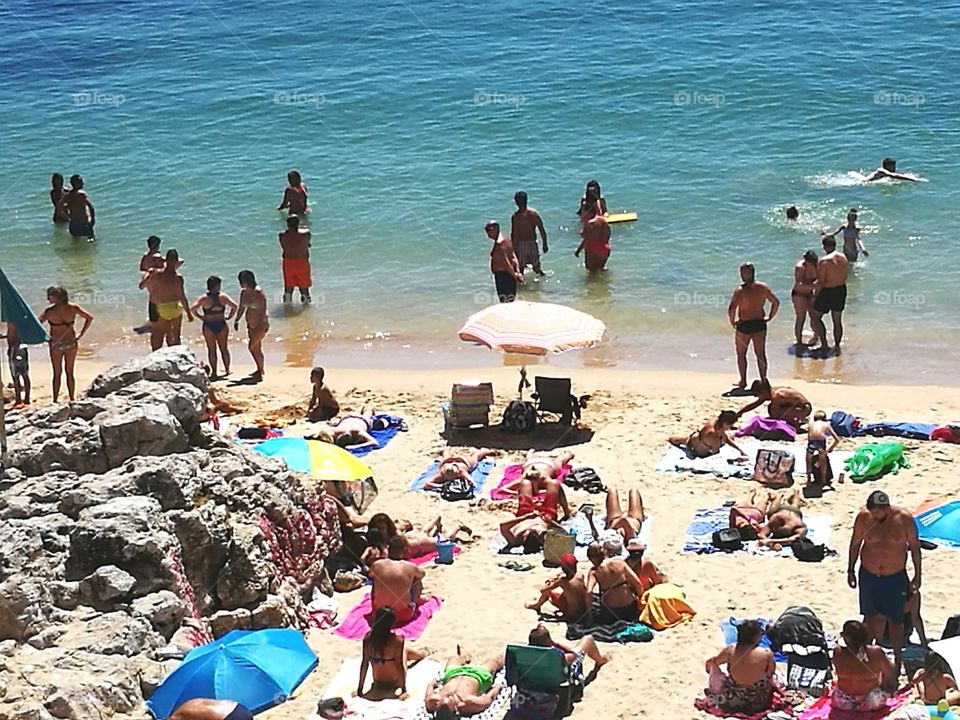 People by the sea in a beach.