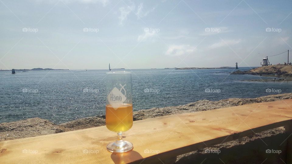 A glass of beer with seaview