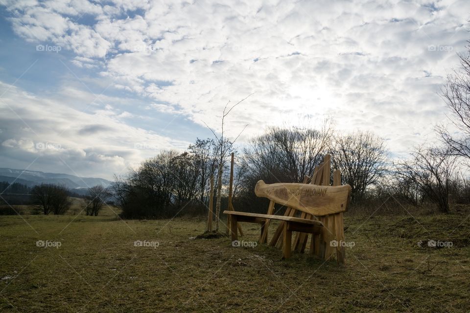Wooden bench on meadow