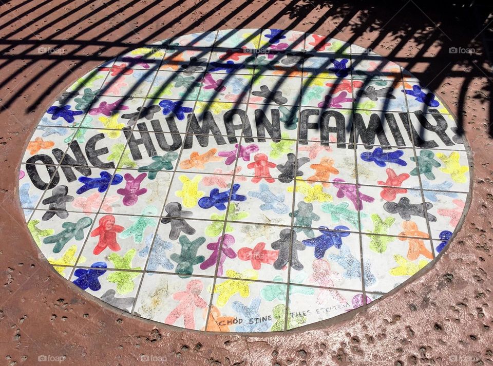 One human family colorful mosaics tiles circle