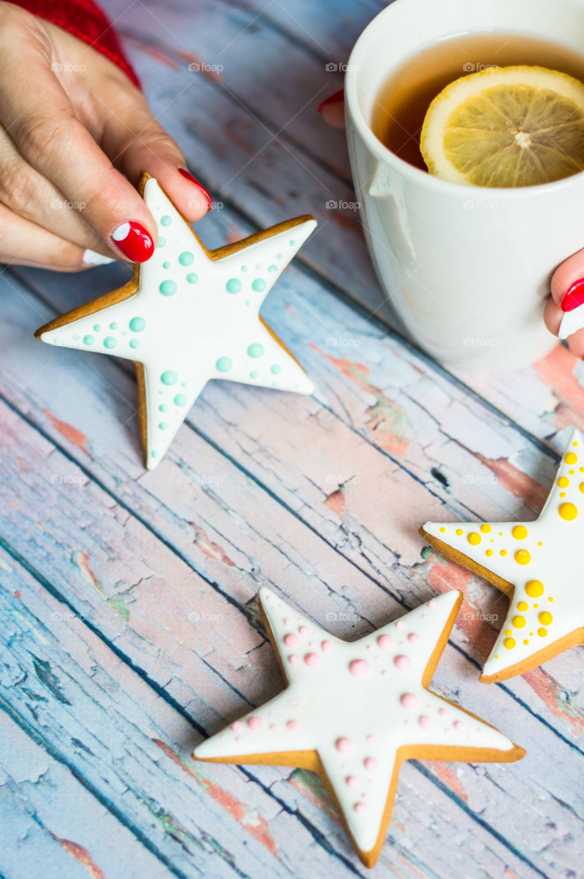 Women holding star shape cookie