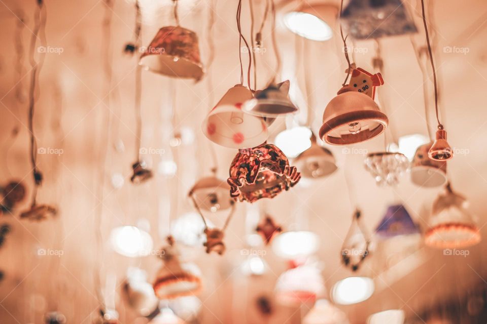 Little hanging items with a lot of light in the background found at the Christmas market.