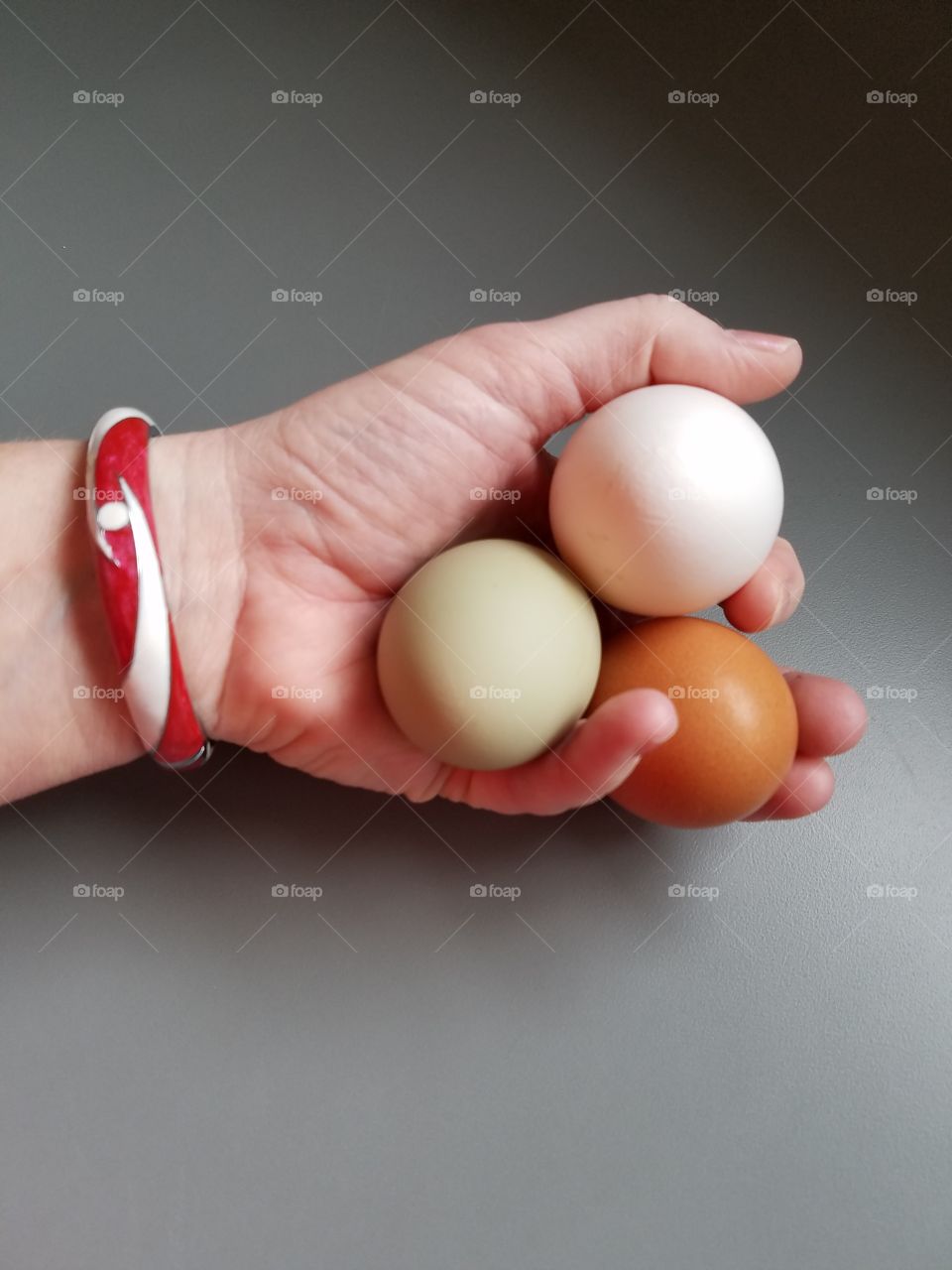 Woman holding variety of egg