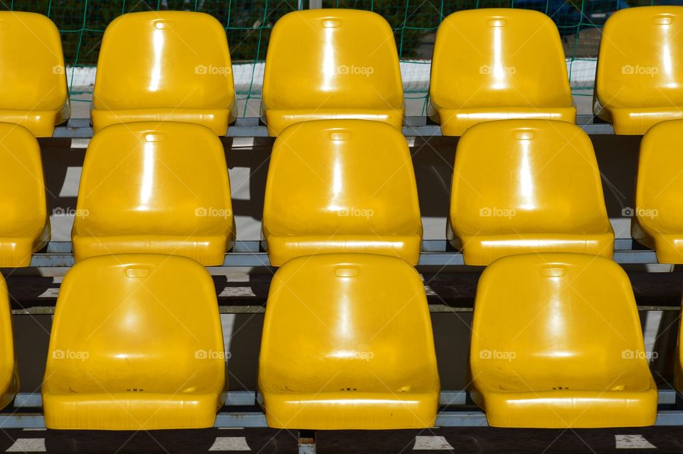 Yellow seats at sunny day