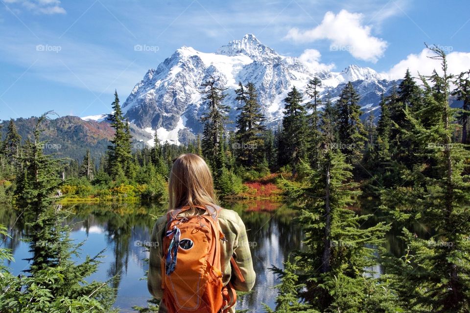 Woman gazing at mountain and lake