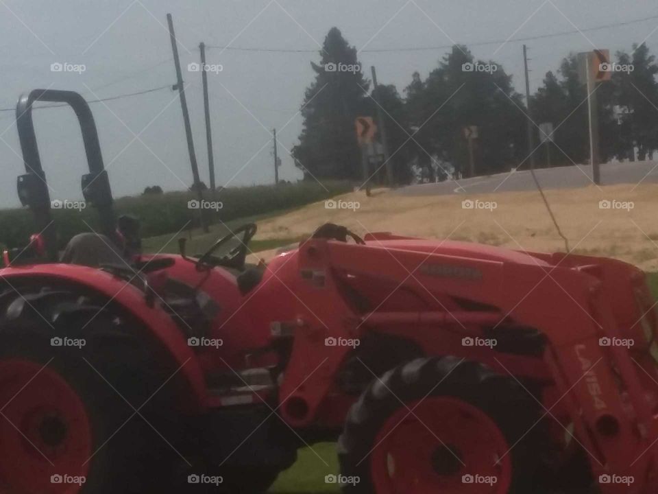 red tractor farm field grass church parking