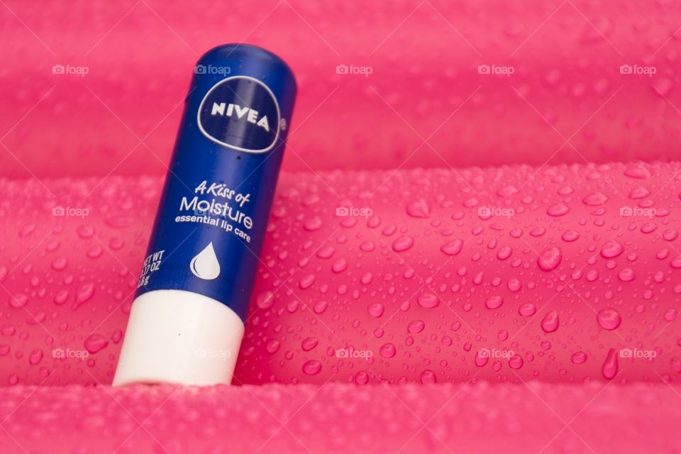 Nivea lip balm in between the raindrops on a air bed 