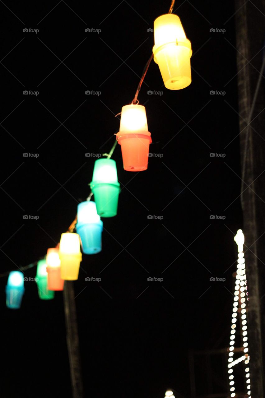 Colourful lanterns hanging in the street at night