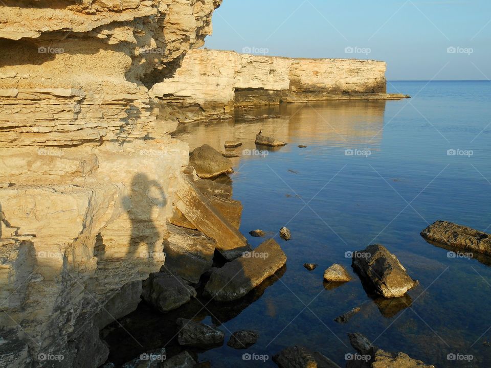 girl shadows on a sunset sea shore summer vacation