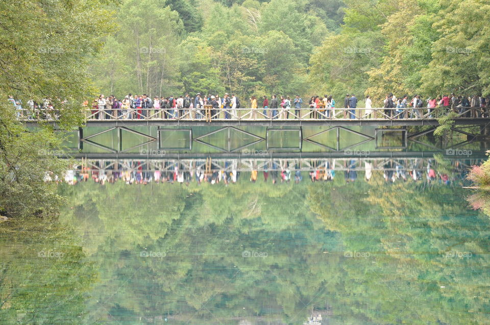 Reflection of people on a bridge in a national park in China