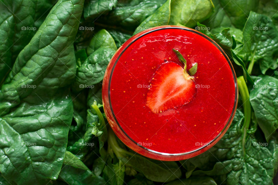 Strawberry smoothie on leaf background