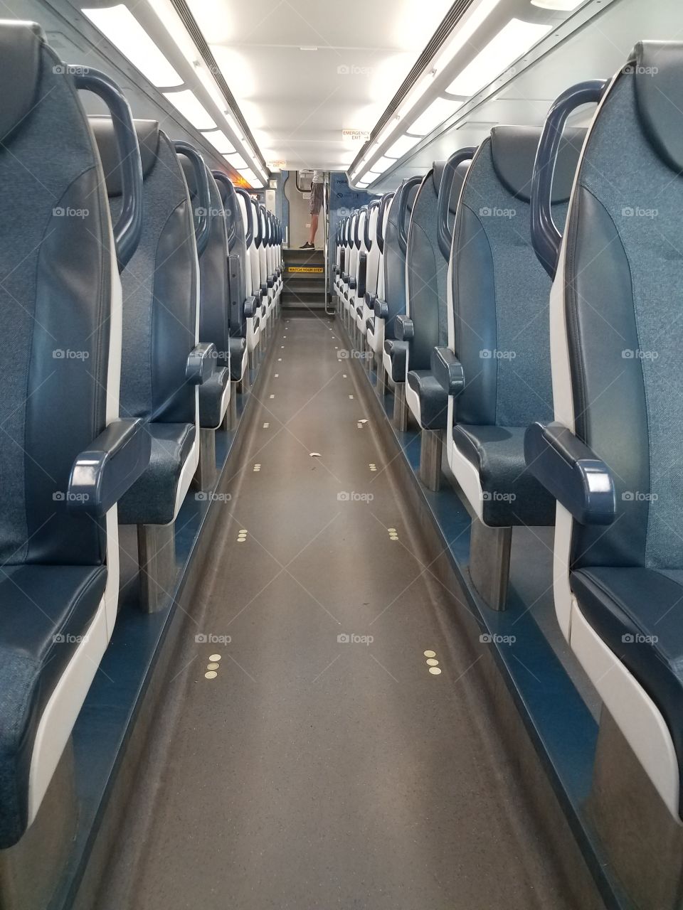 An empty car of a commuter train.