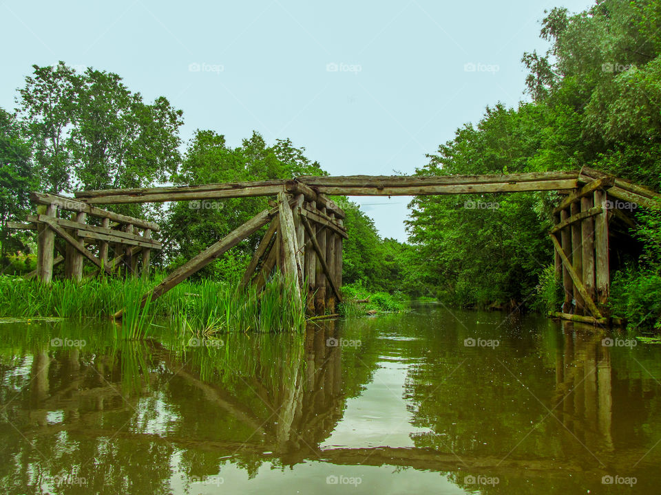 old collapsed wooden bridge over the bridge