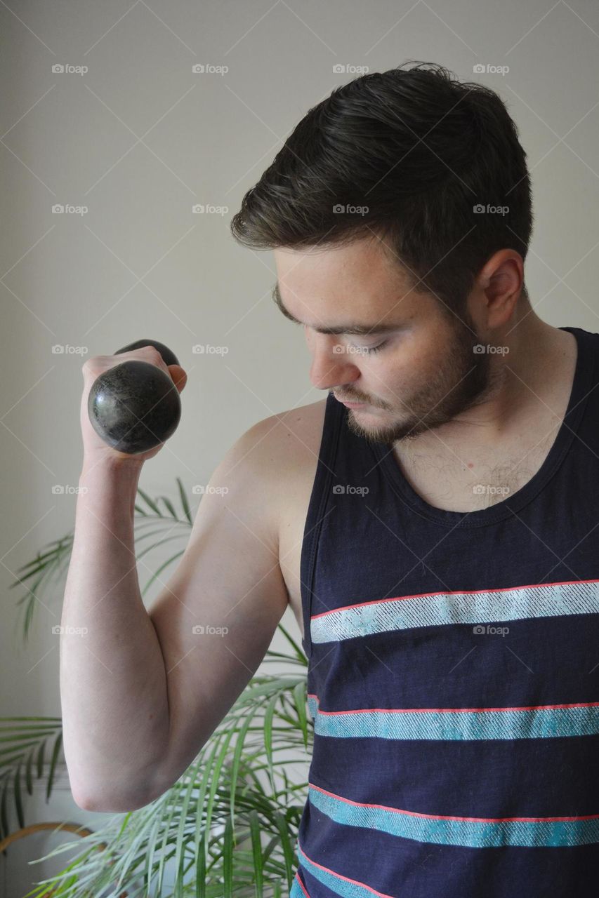 men training indoor, dumbbell in the hand